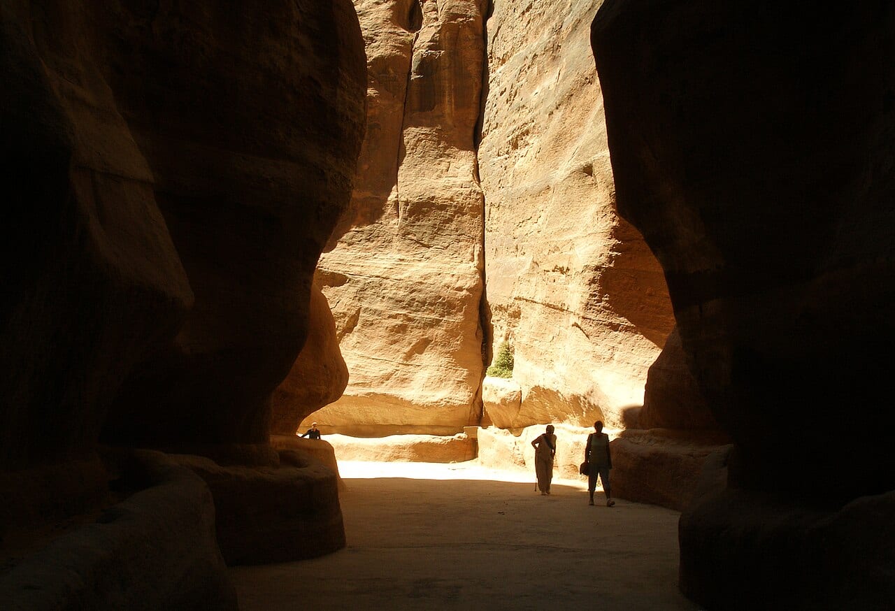 The narrow sandstone walls of the Siq leading into Petra