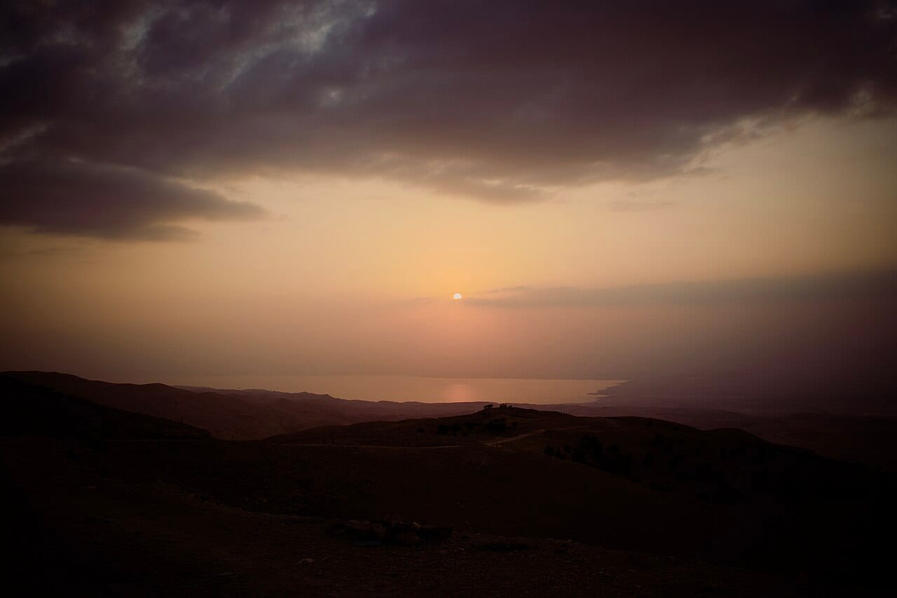 The sun setting over the Dead Sea seen from the hills of Mount Nebo