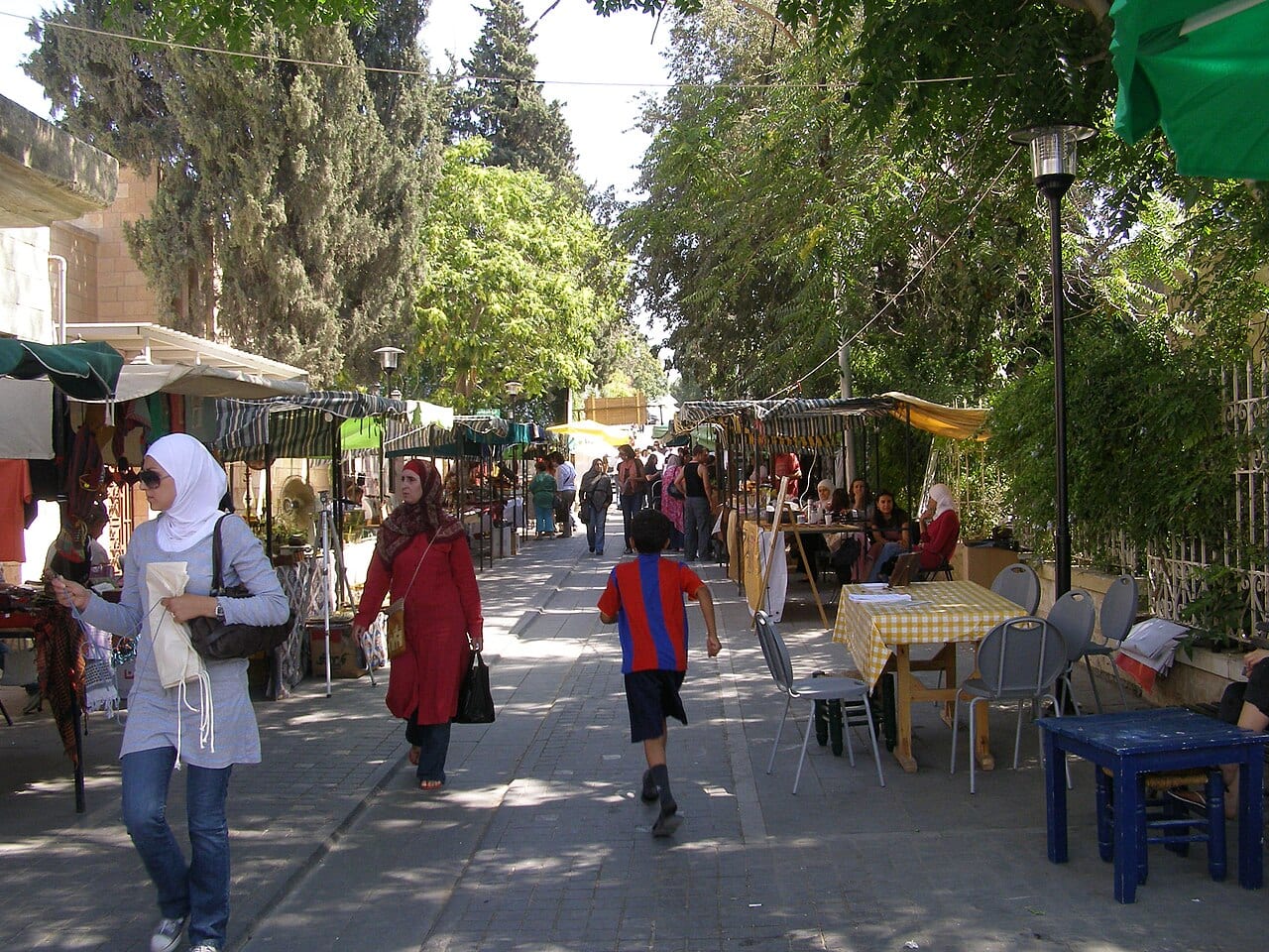 Families walking between stalls at the Souk Jara street market in Jabal Amman