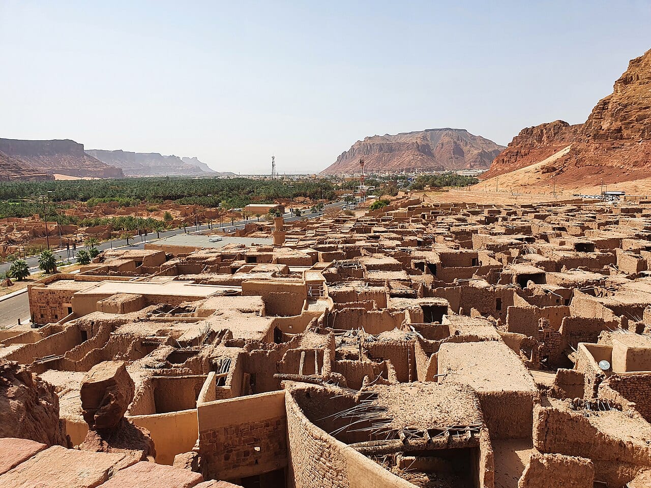 Rooftops of the mudbrick Old Town of AlUla below the sandstone cliffs
