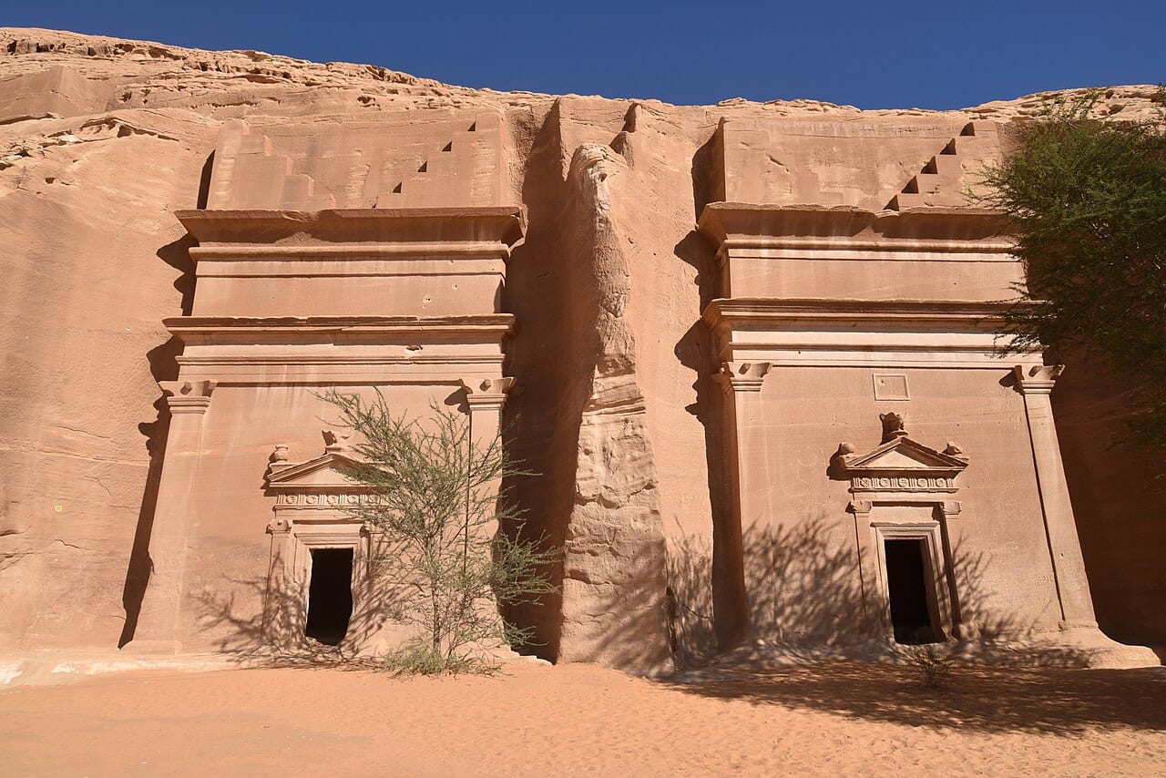 Two carved Nabataean tomb facades side by side at Hegra