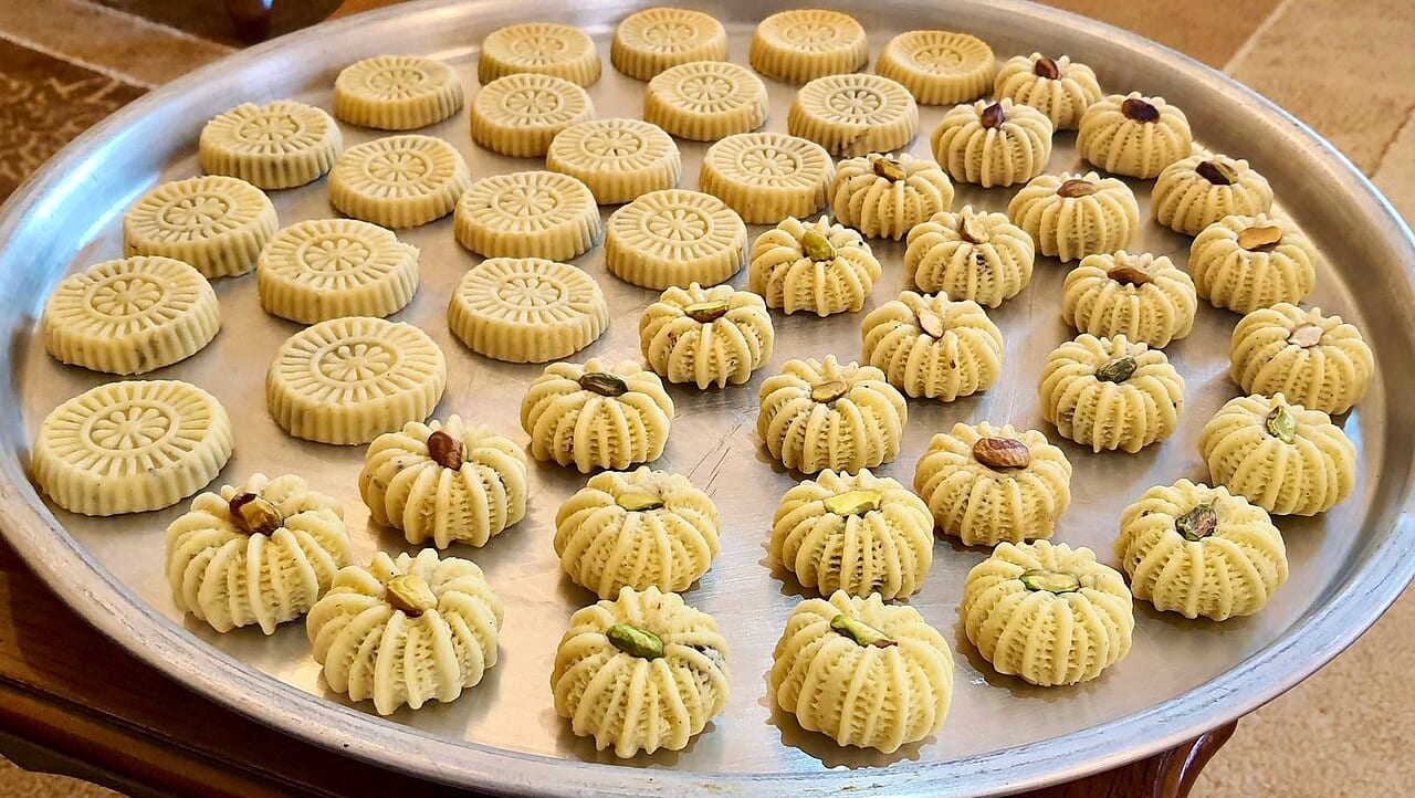 Ma'amoul cookies filled with dates and nuts arranged on a tray