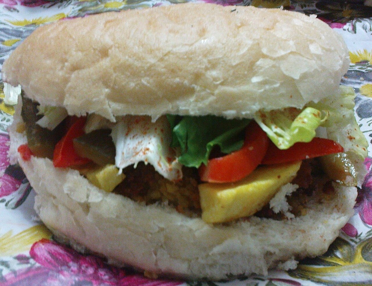 A falafel sandwich wrapped in Arabic bread
