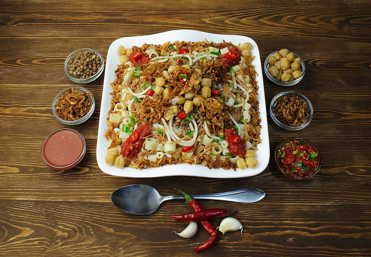 A plate of Egyptian koshari with lentils, rice, pasta and fried onions