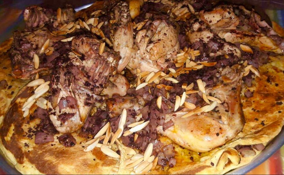 Musakhan: taboon bread topped with sumac onions and roast chicken