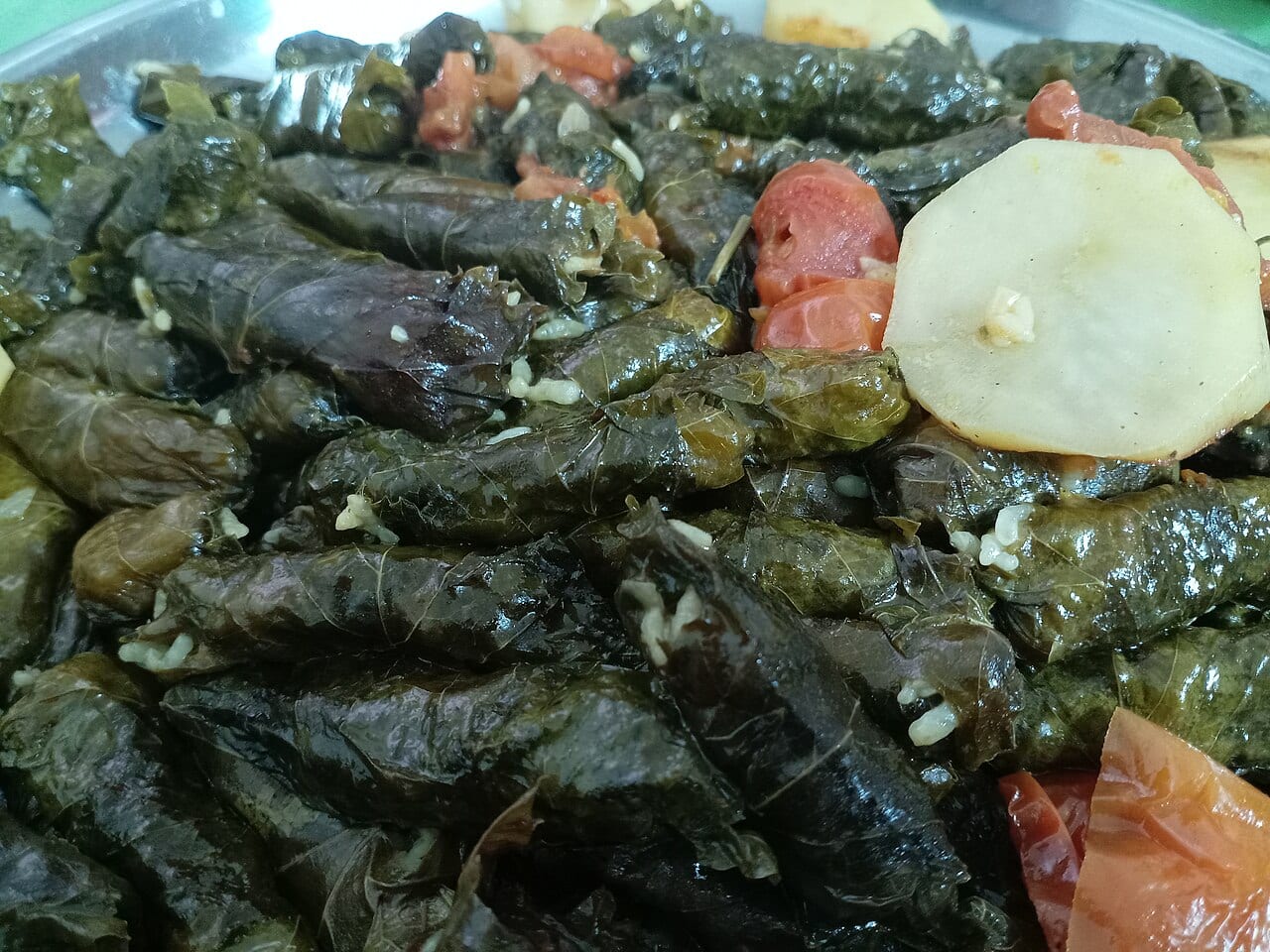 A pot of stuffed vine leaves and vegetables cooked the Jordanian way