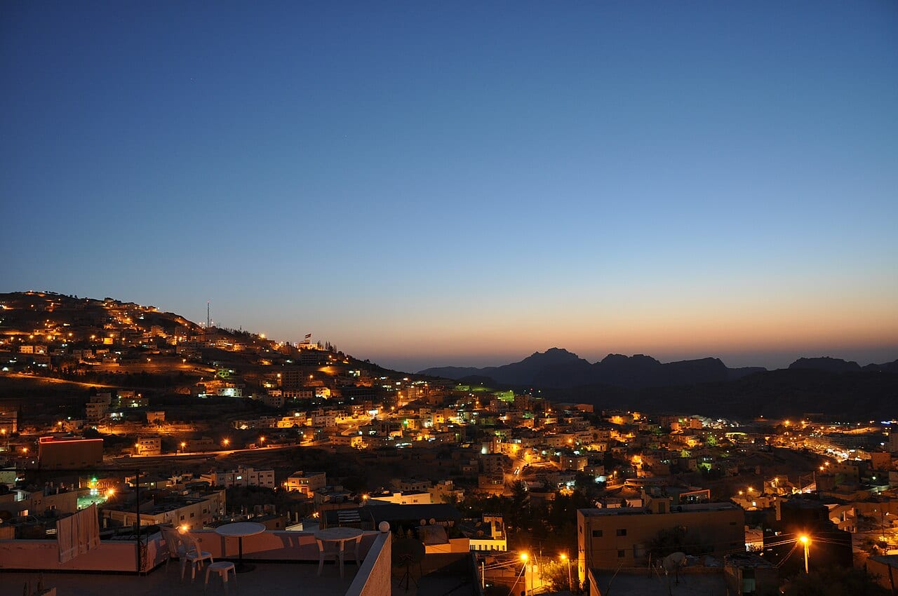 The town of Wadi Musa lit up at dusk on the hills above Petra