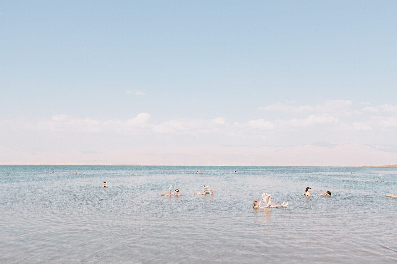 A visitor floating effortlessly on the very salty water of the Dead Sea