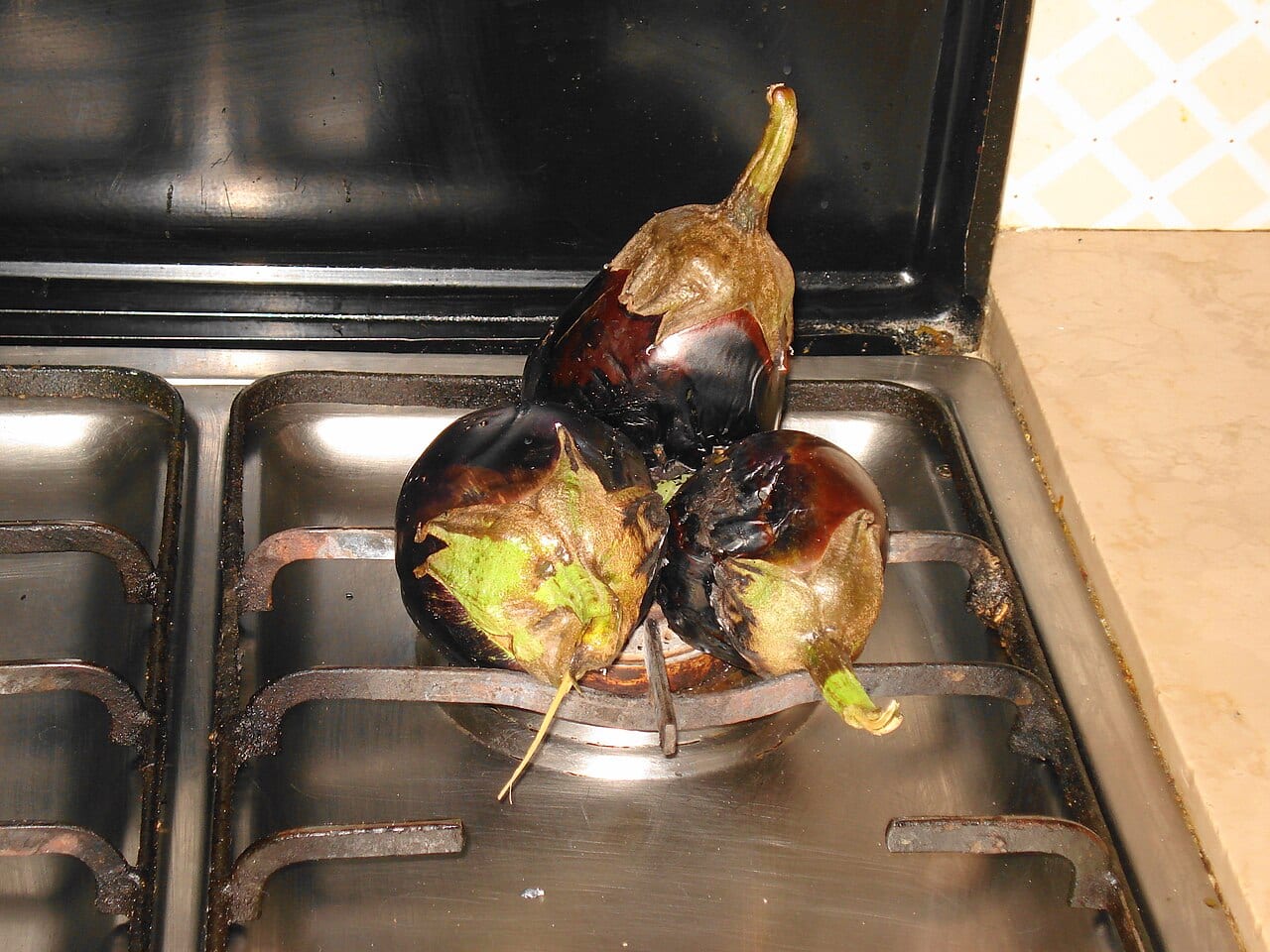 Aubergines charring over an open gas flame for mutabbal