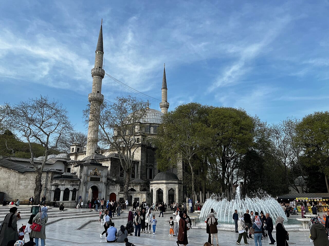 Visitors in the square in front of the Eyüp Sultan Mosque with its tall minarets