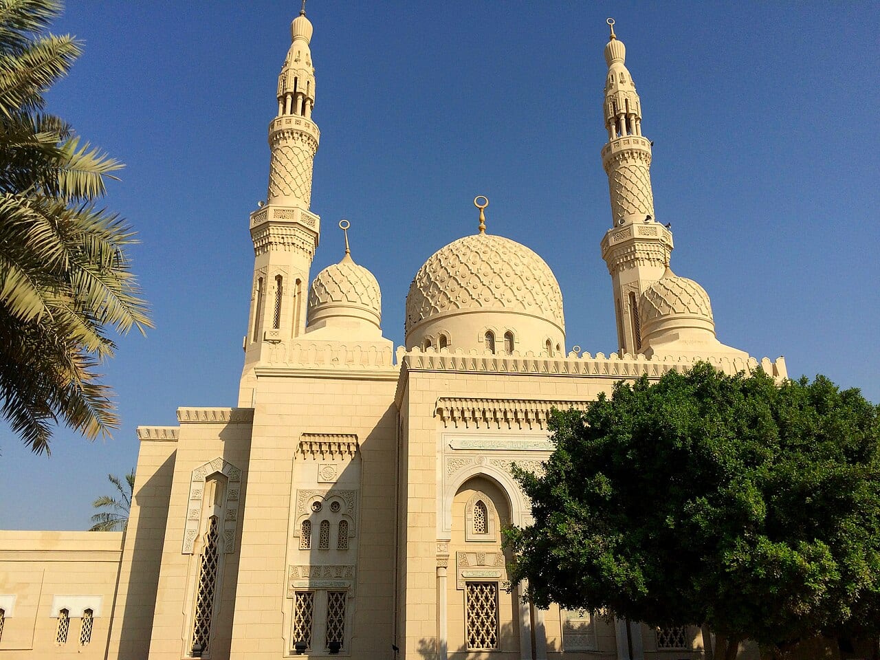 Jumeirah Mosque with its twin minarets and cream stone under a clear sky