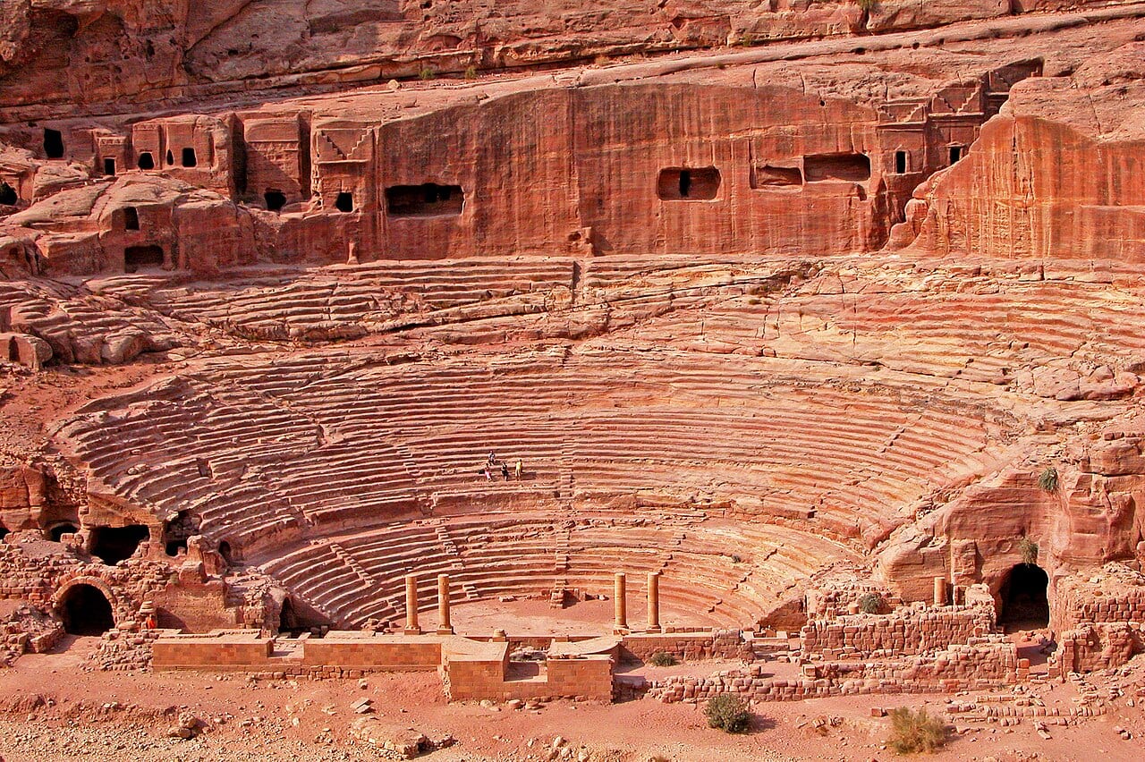 The Nabataean theatre at Petra, its seating carved into the red sandstone hillside